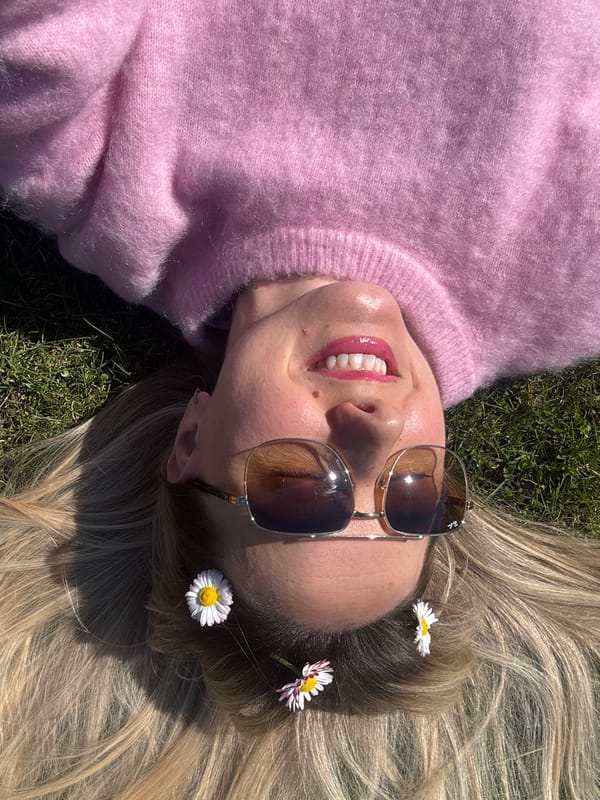 Woman relaxes on grass in sunny Carnikava, Latvia