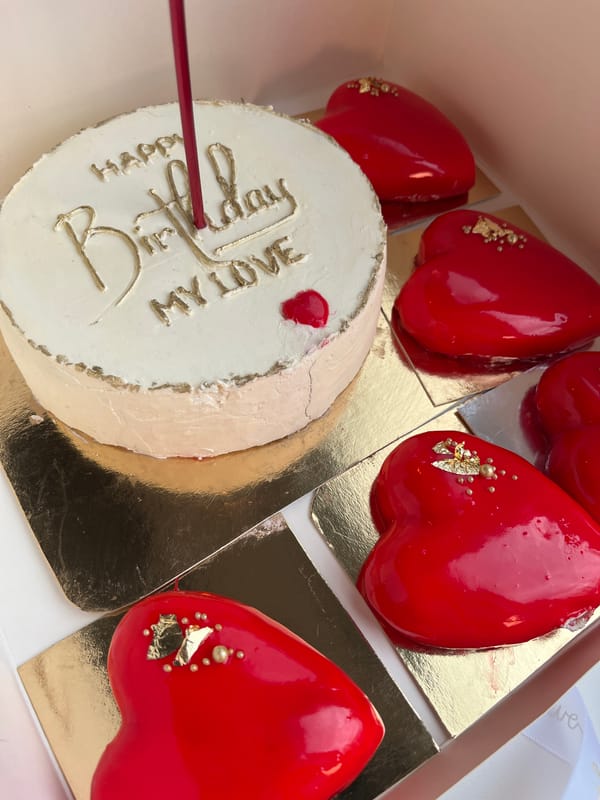 Ornate heart pastries and decorated cake observed in box