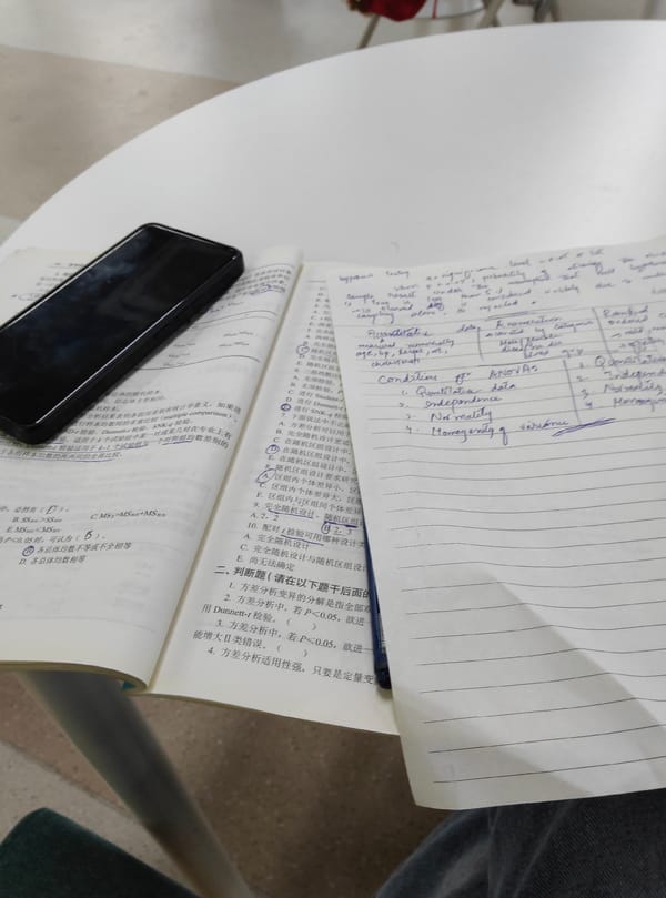 Studying at a café with notes, textbooks, and bubble tea