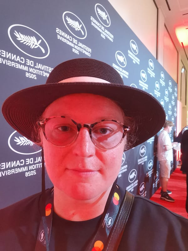 Person photographed at event backdrop in Cannes, France
