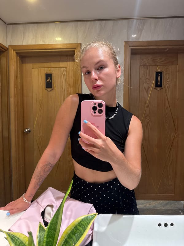 Mirror selfie in a Nha Trang restroom, July 2026