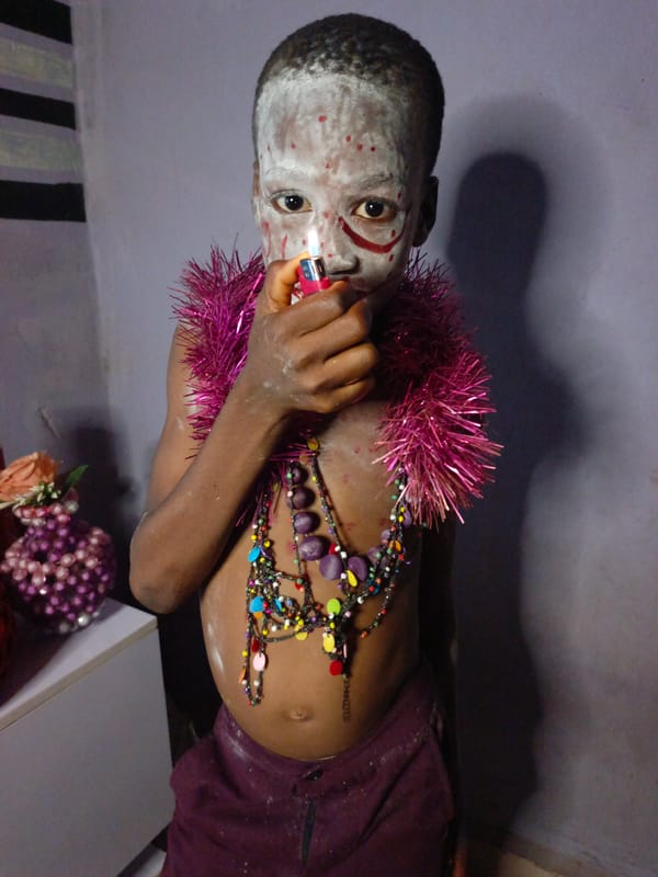 Face painting session documented with child and Joker costume