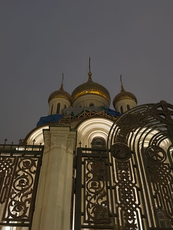 Orthodox church with golden domes illuminated at night in Moscow