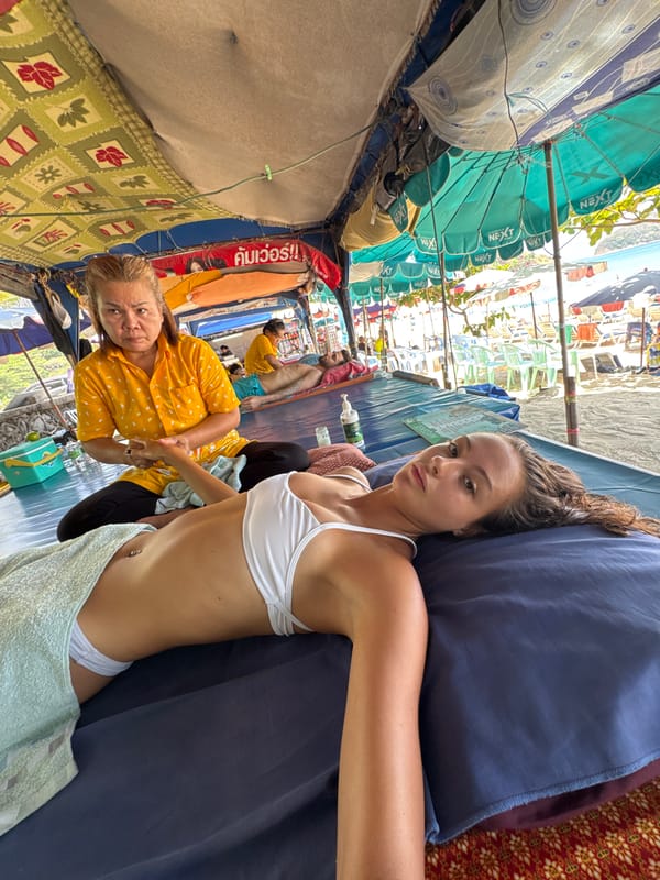 Tourist documents beachside massage experience in Rawai Thailand