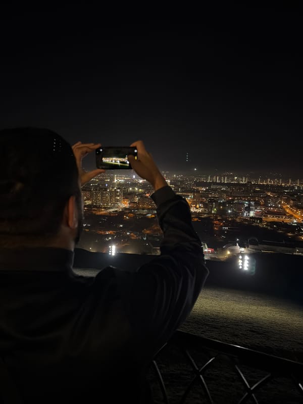 Tourist photographs Krasnoyarsk city skyline from observation deck