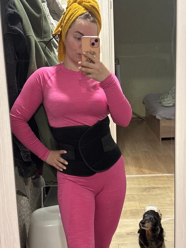Person takes mirror selfie in pink athletic wear, Izhevsk