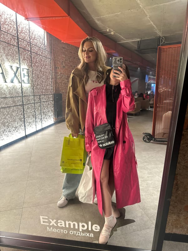 Women take mirror selfies in Kazan commercial building