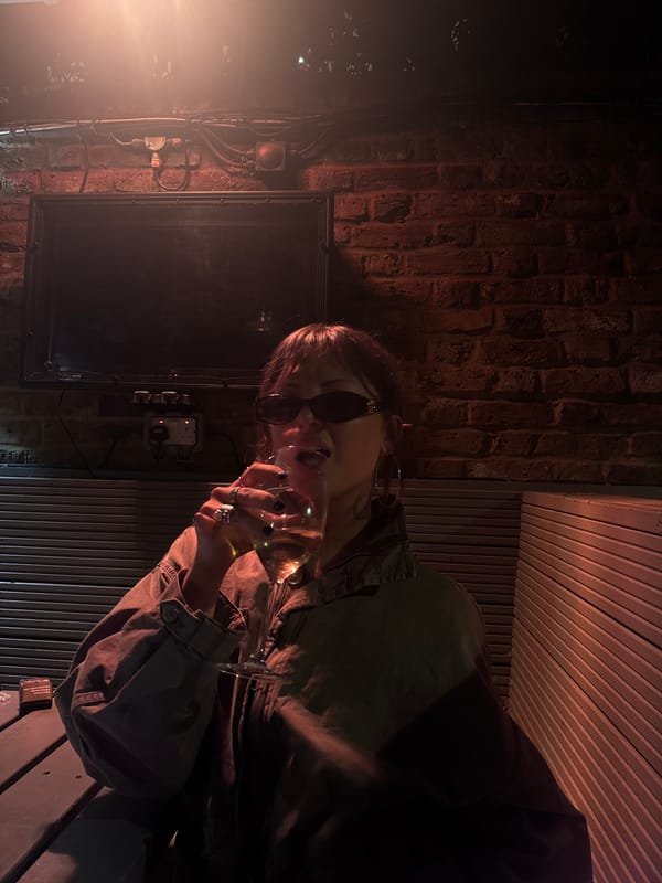 Person with drink captured in dimly lit London scene