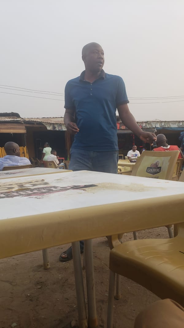 Woman cleans tables at outdoor establishment in Narayi Nigeria