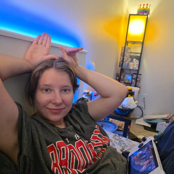 Late-night bedroom hang with a cat and a controller