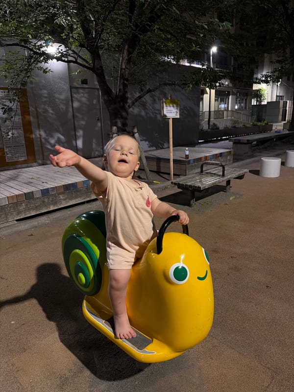 Night playground time on yellow snail rider in Chuo