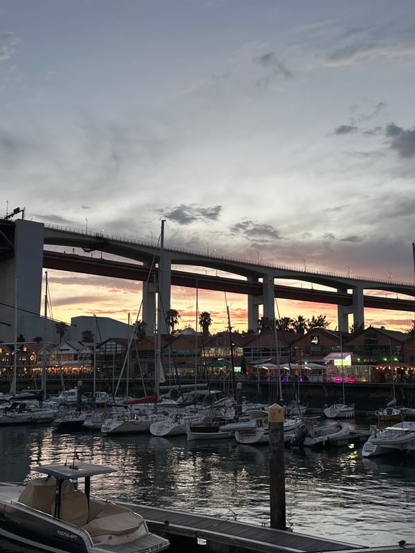 Dusk under Lisbon's bridge, plane passing overhead
