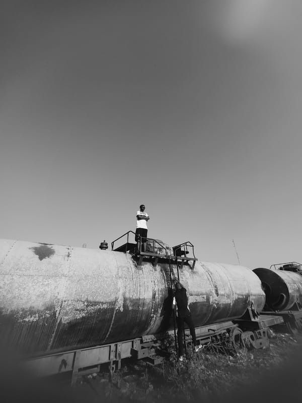 Workers conduct maintenance on industrial tanks in Kinkinau, Nigeria