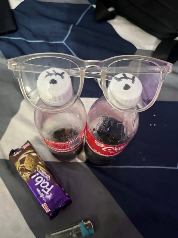 Coke bottles and glasses arranged on bed in Lokoja