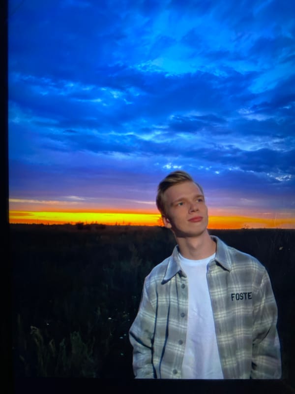 Standing in a field at golden hour, watching the sunset