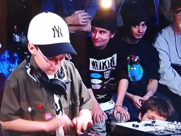 Yankees fan operates equipment indoors amid group gathering