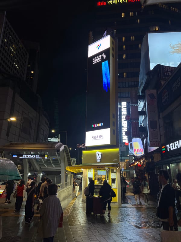 Rainy night on Seoul's busy Myeongdong street food strip