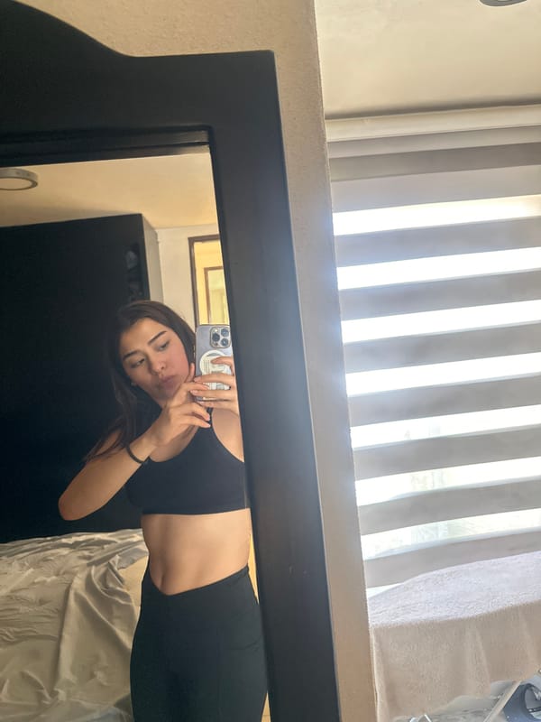 Young woman takes mirror selfie in Puebla room
