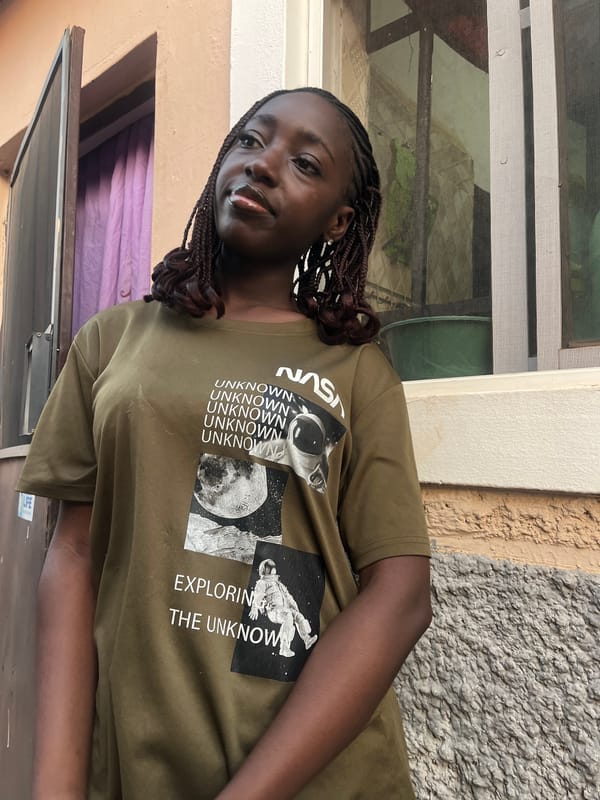 Woman in NASA shirt photographed around Abuja neighborhoods