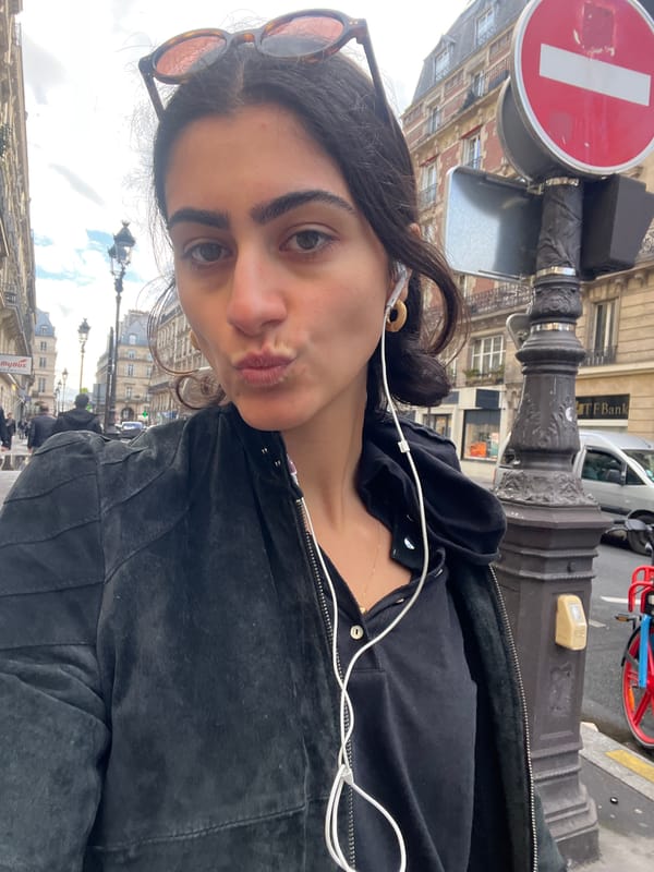Woman takes selfie on Parisian street amid iconic architecture