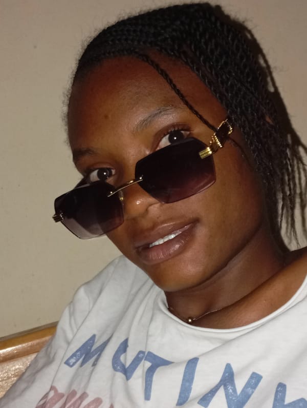 Young woman in sunglasses photographed smiling at camera
