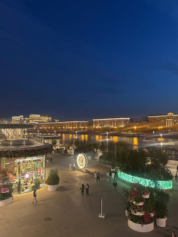 Evening stroll captured along Moscow's illuminated Luzhkov Bridge waterfront