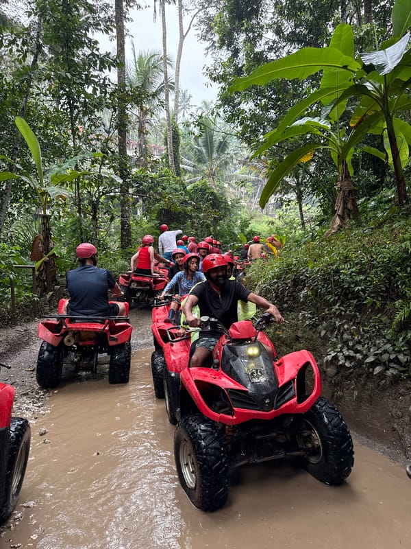 ATV group rides muddy trails through tropical Payangan jungle