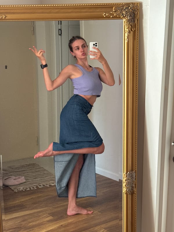 Woman takes mirror selfies indoors, urban hillside views captured