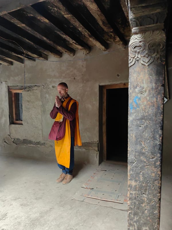 Buddhist monks and cloudy peaks at a remote Himalayan village