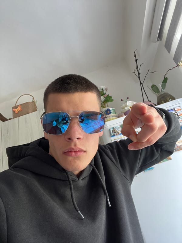 Person in sunglasses poses playfully indoors in Sopot, Bulgaria