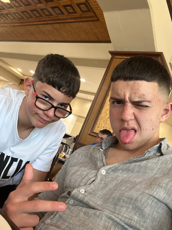 Teenagers take playful selfies at Kalabaka restaurant during tourist lunch