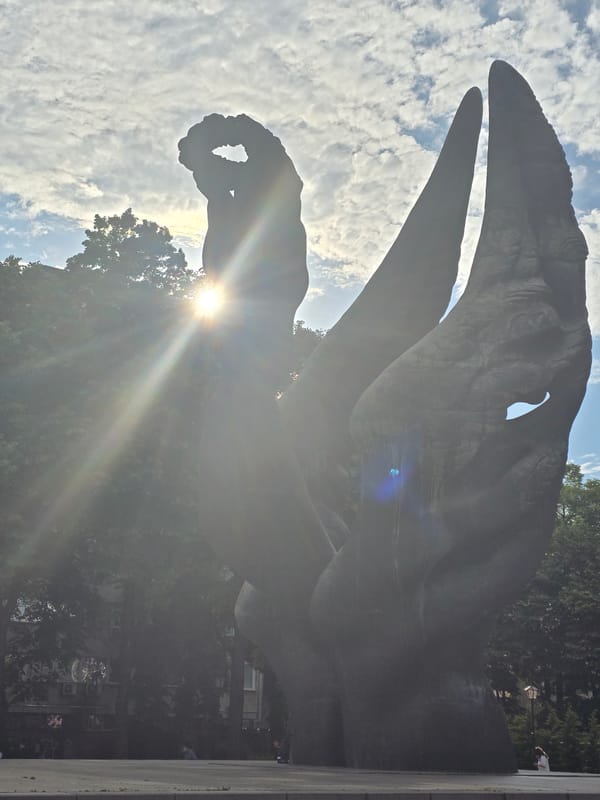 Urban afternoon scenes: traffic, sculptures, parked cars documented