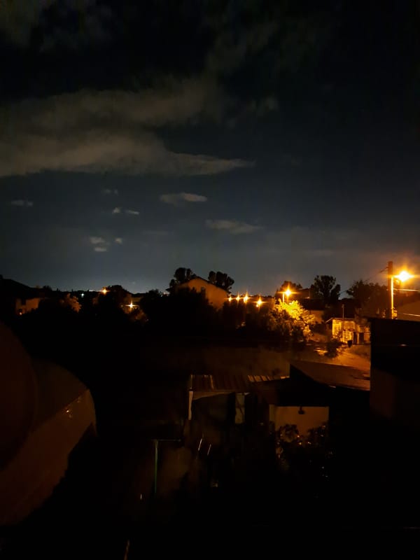 Evening documented in Chepintsi: streetlights, crescent moon, casual meal