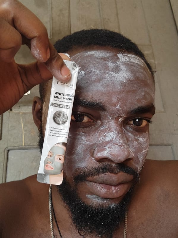 Man applies facial masks during skincare routine in Jos