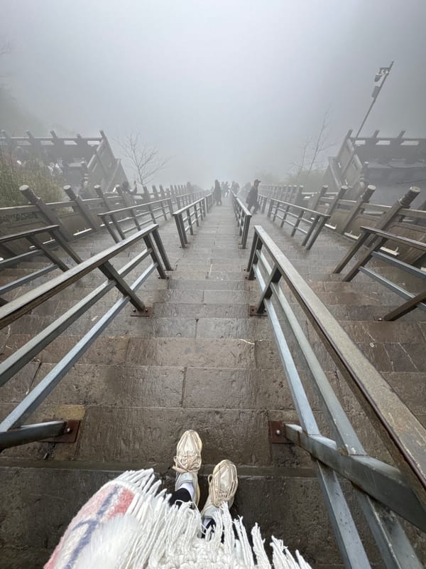 Tourist documents foggy morning exploration of Zhangjiajie's Heavenly Gate Mountain