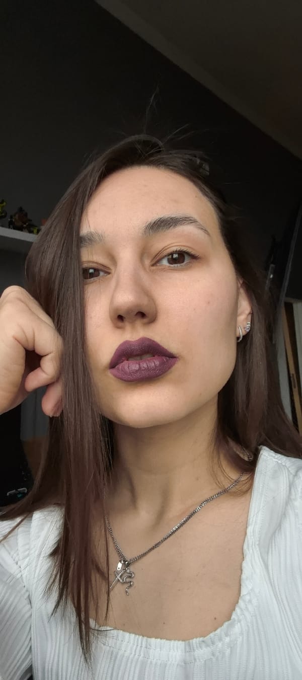 Woman Takes Mirror Selfies with Phone and Makeup