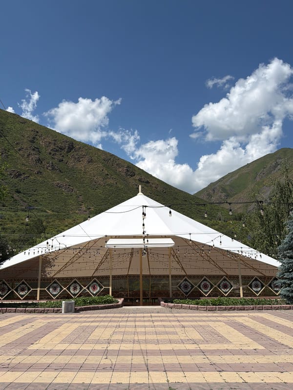 Visitors document folk park with yurts and traditional structures