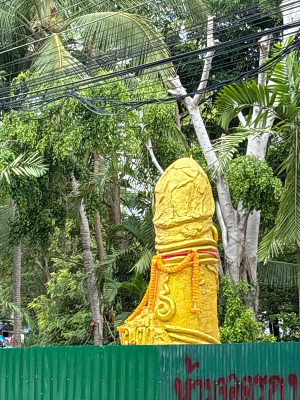 Decorated fertility statue spotted amid tropical vegetation in Thailand