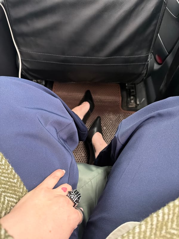 Person in navy trousers photographed in vehicle, Moscow