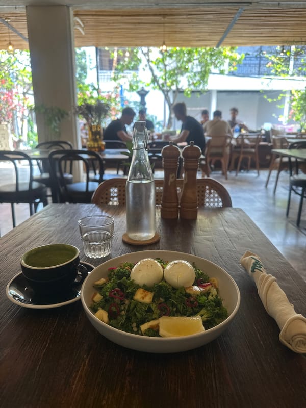 Café breakfast spread: kale salad, poached eggs, and matcha latte