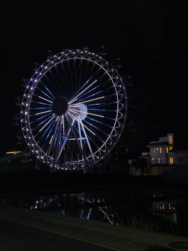 Illuminated ferris wheel lights up the night in North Kuta