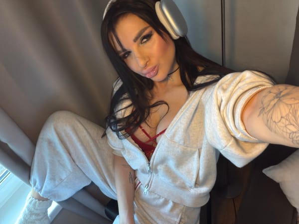 Woman sits indoors in casual attire in Russia