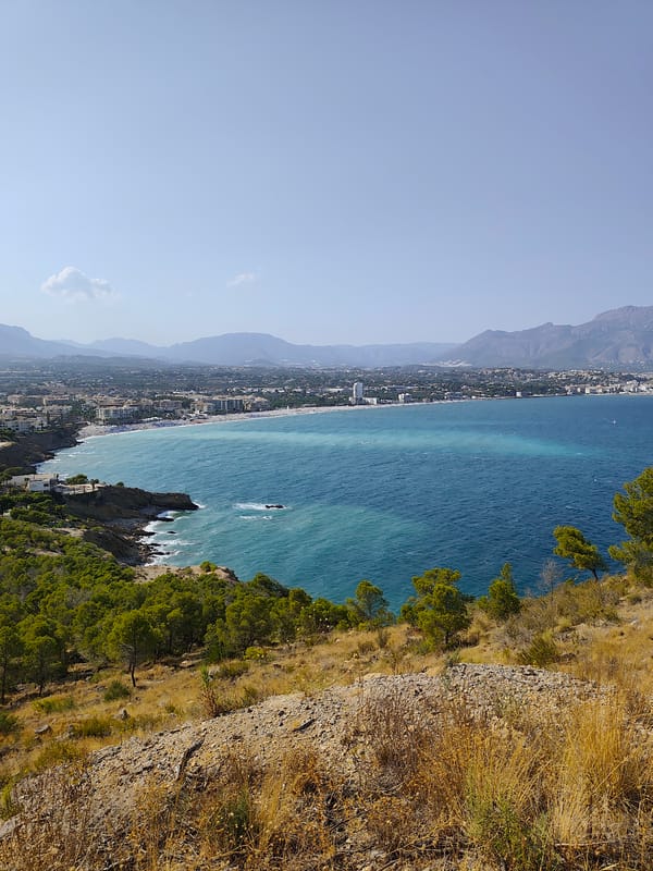 Rocky Mediterranean hillside with tunnel path and sea views