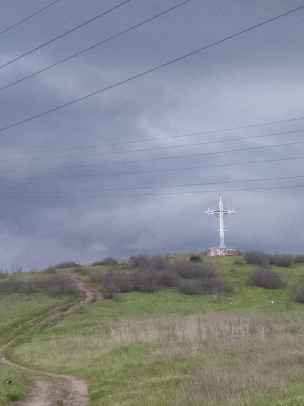 Metallic cross observed on hill under stormy skies, Burgas