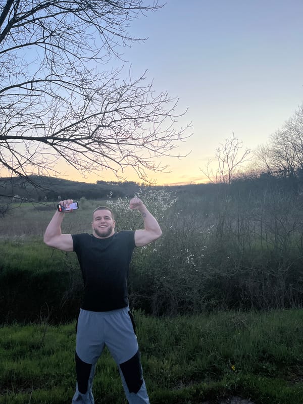 Man poses with phone in field near Burgas, Bulgaria