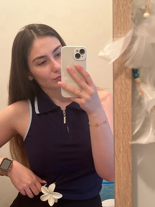 Woman documents mirror selfie session in home setting
