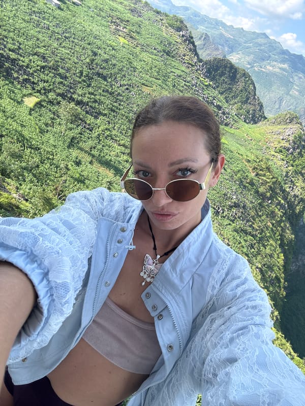 Tourists photograph scenic mountain valley overlook in northern Vietnam