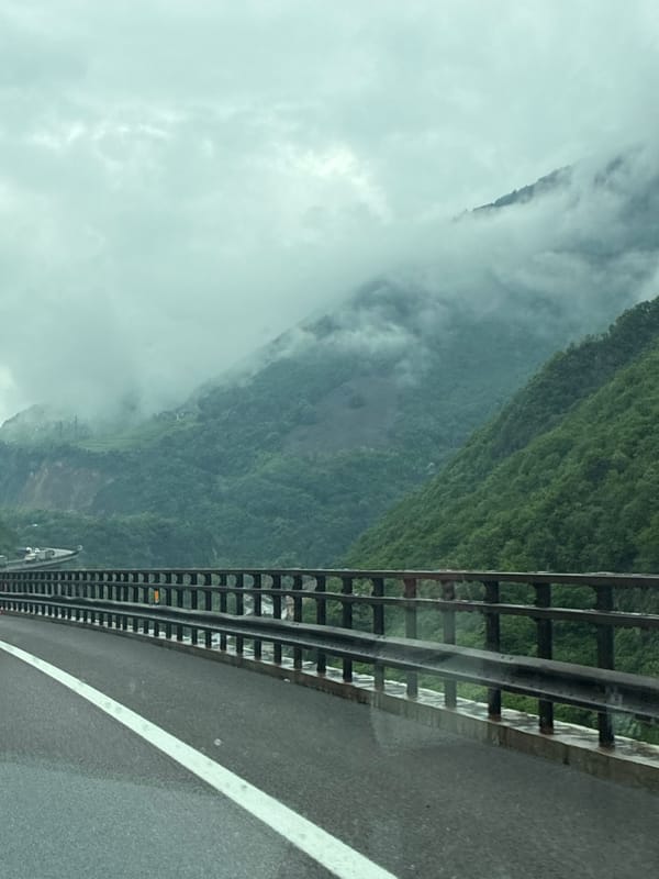 Morning fog observed from roadway in Italian Alpine village