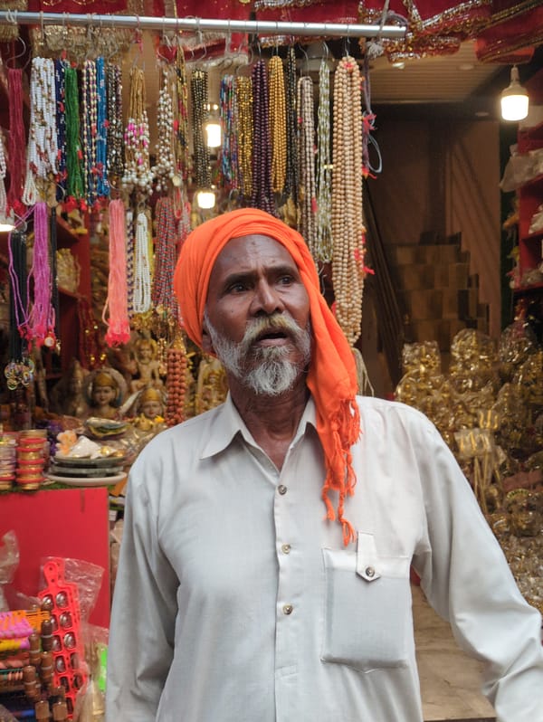 Kangra street market with vendors, shoppers, and henna work