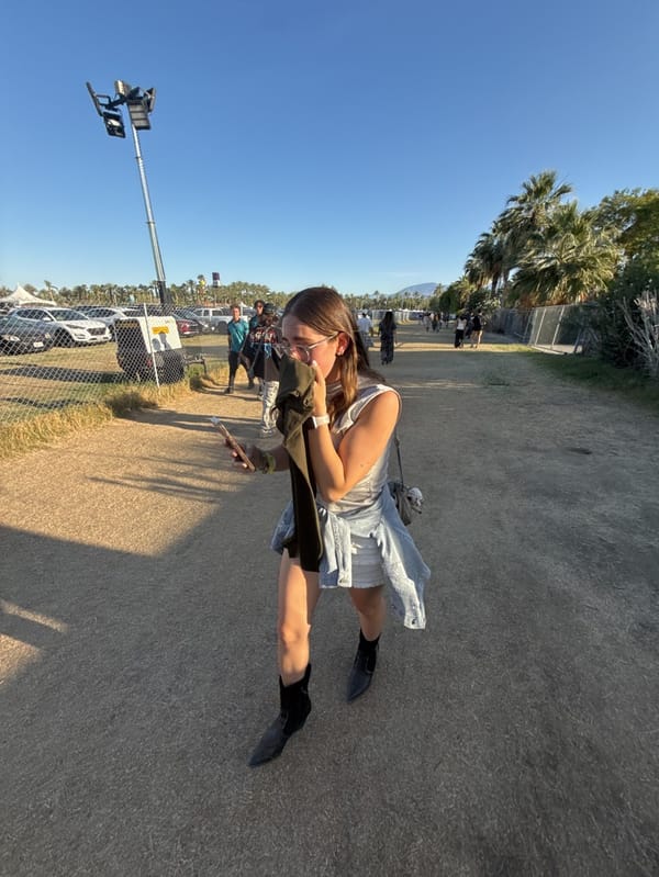 Young women walk festival grounds in Indio, California